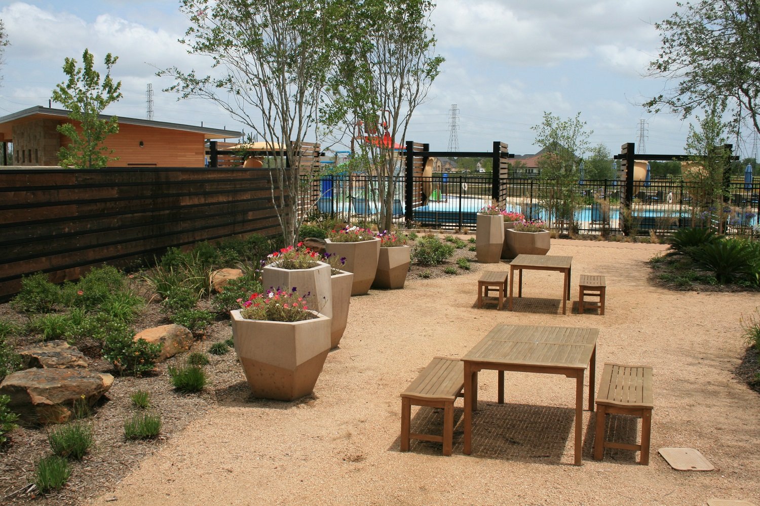 HOA common area with planters and tables