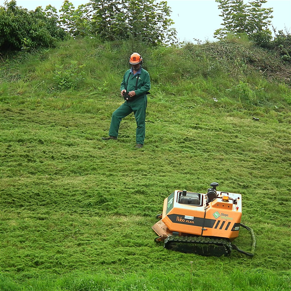 Remote controlled lawn mower used on a steep slope