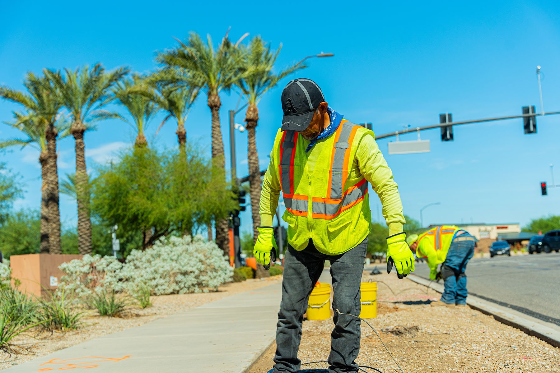 Landscape crew member working along roadway 
