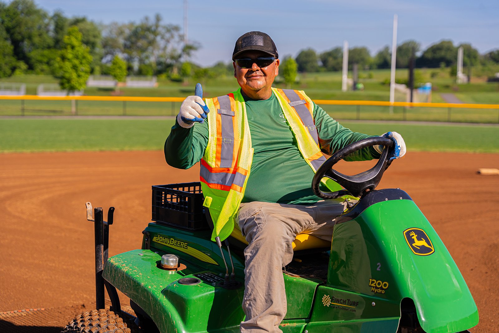 Worker smiling on softball field