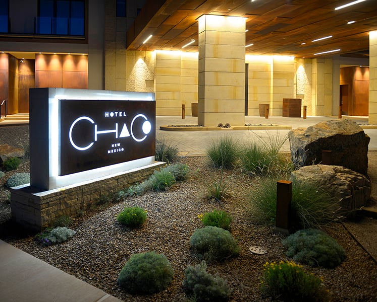 Hotel Chaco entrance with boulders, stone mulch and flowers