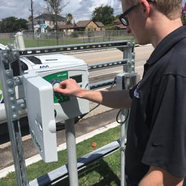 Irrigation technician adjusting a smart controller