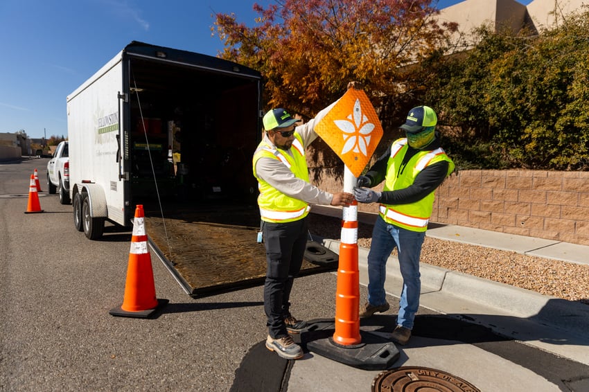 Crew putting up safety cone