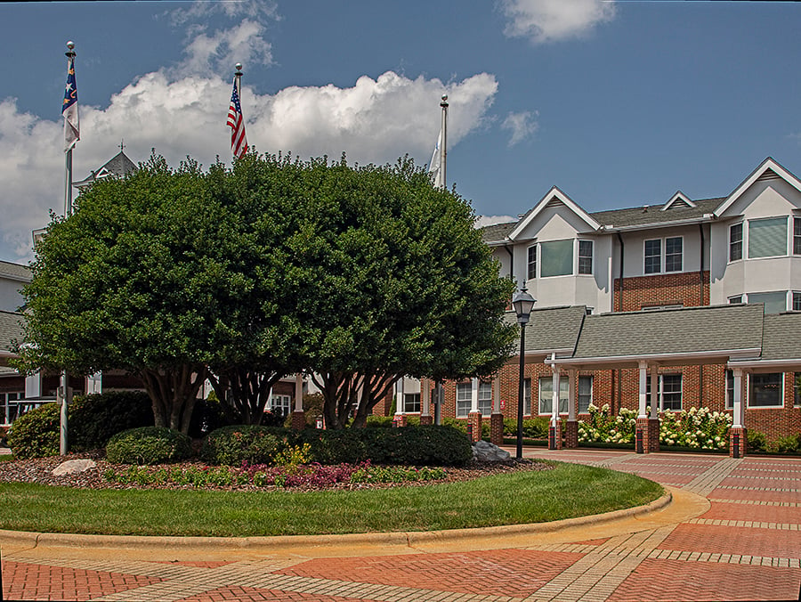 entrance at senior living community with well maintained landscape