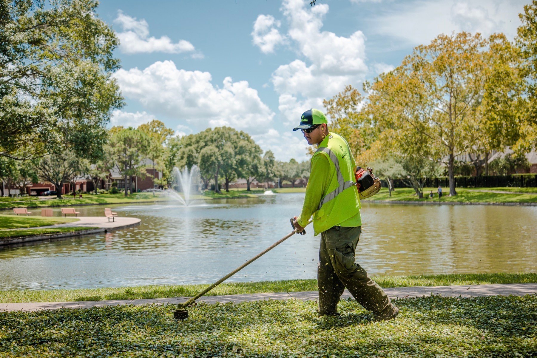 Maintenance team trimming grass