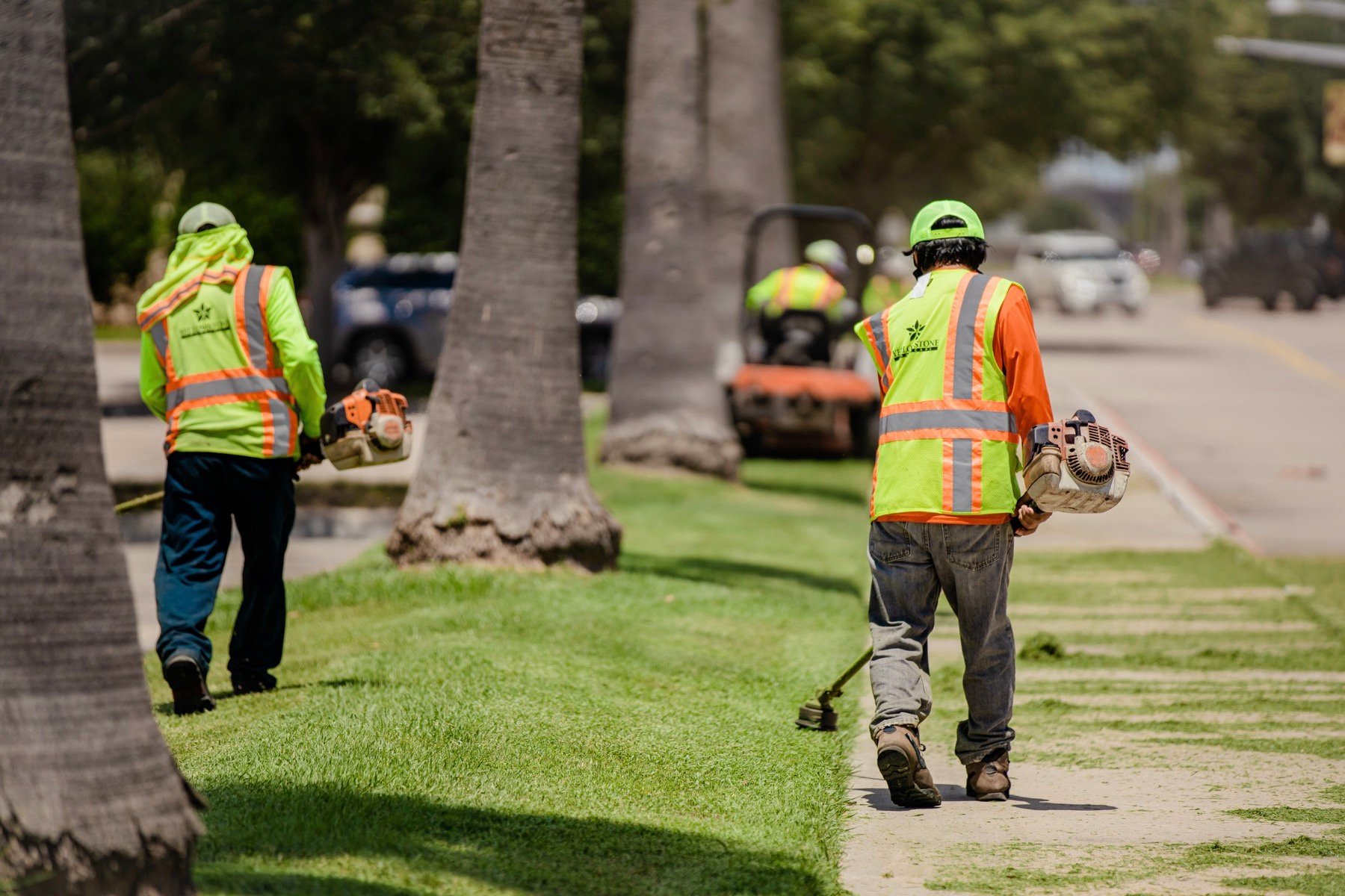 Lawn care team trimming grass