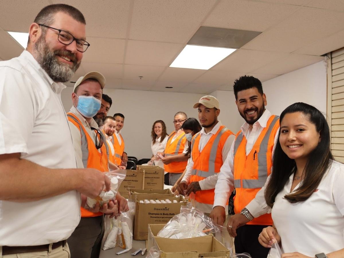 yellowstone landscaping team packs bags for homeless