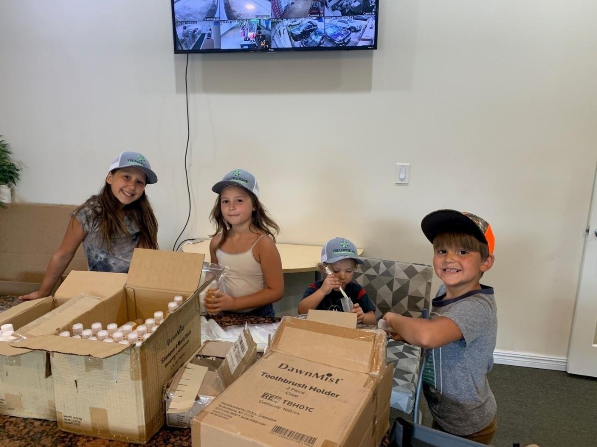 kids at yellowstone landscaping packing kits for homeless
