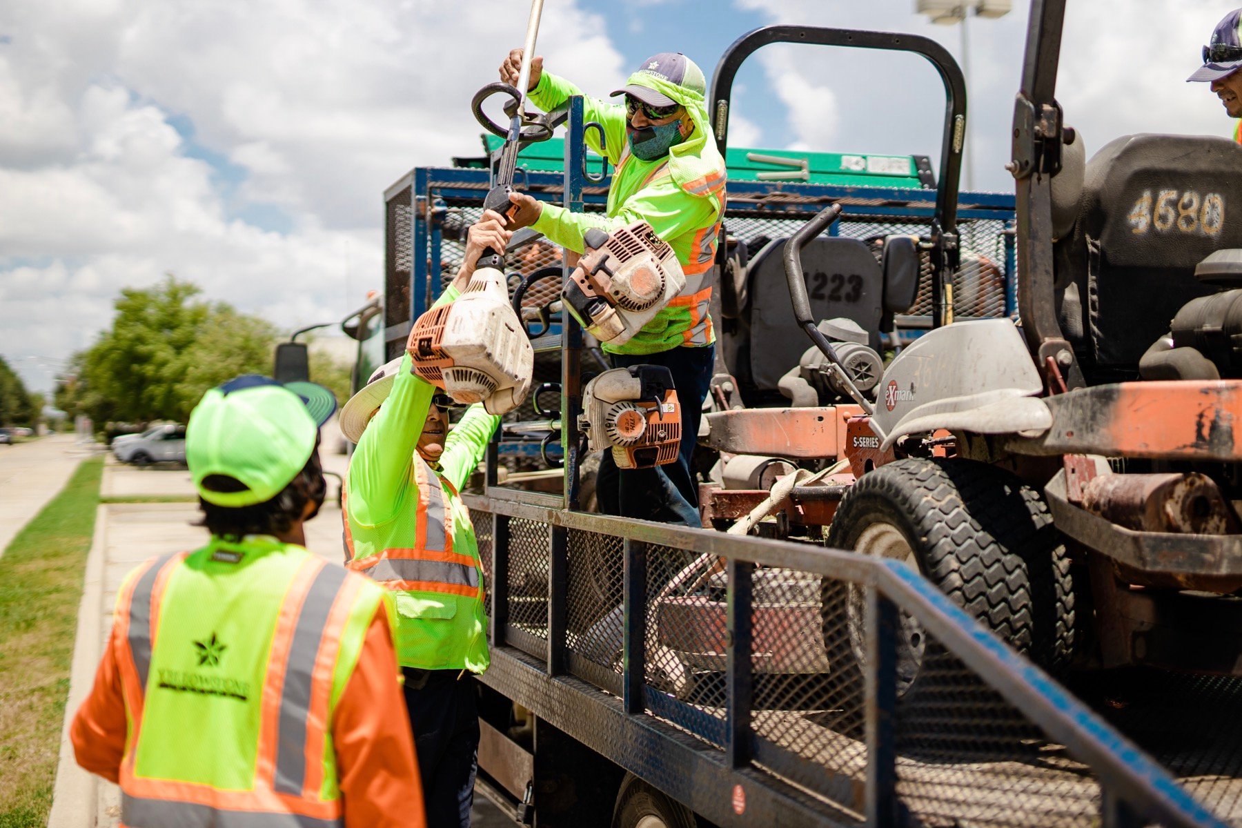 Landscape maintenance crew loading equipment onto a trailer