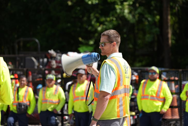 man wearing safety vest with megaphone