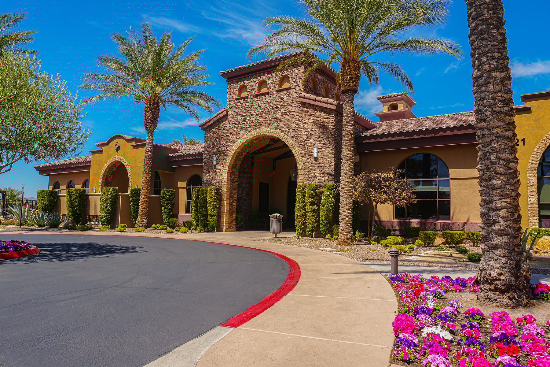 Spanish style entrance with palms | Yellowstone Landscape 