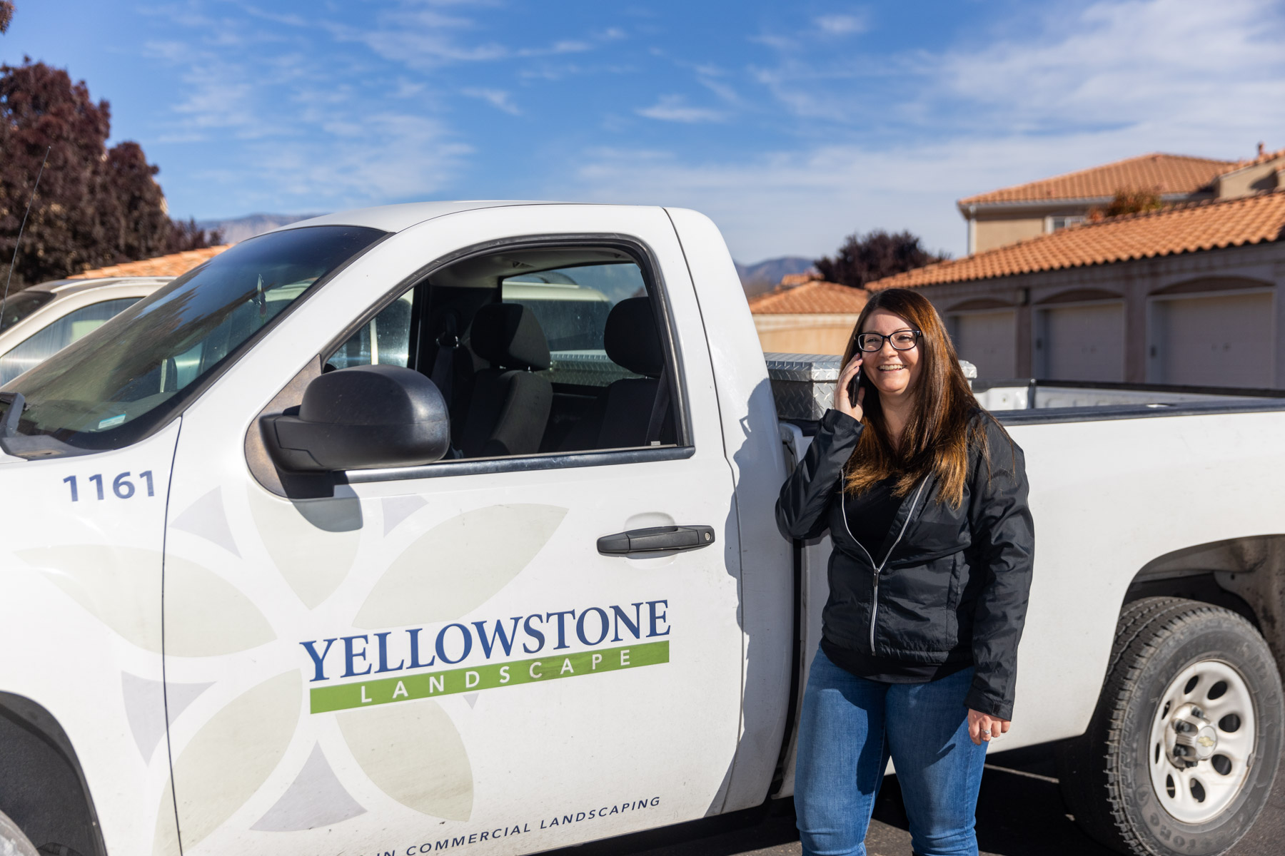 business development manager stands in front of truck